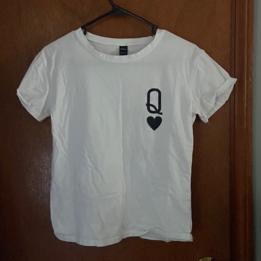 White tee shirt with black Q on left chest